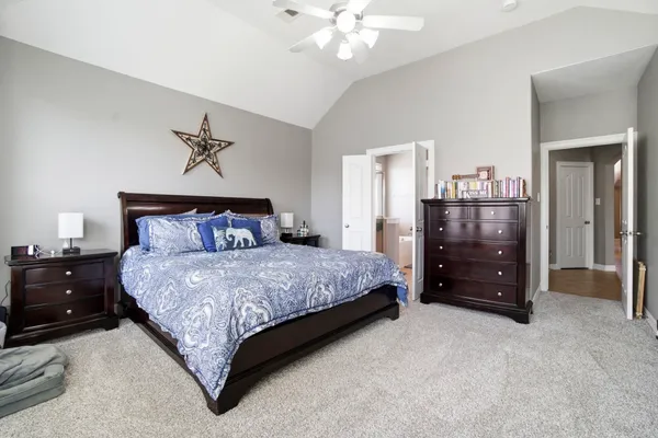 a bathroom with a tub shower and mirror