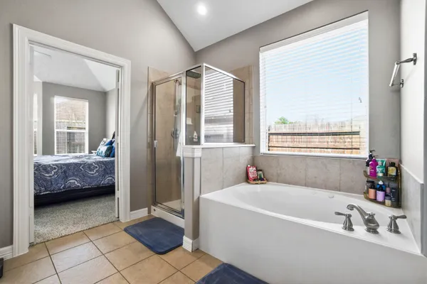 a view of walk in closet with clothes