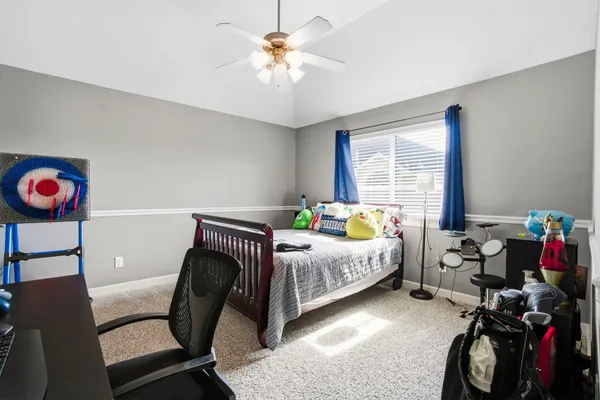 a bedroom with two beds and a chandelier