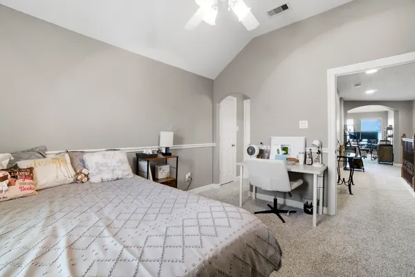 a bedroom with a bed and a chandelier