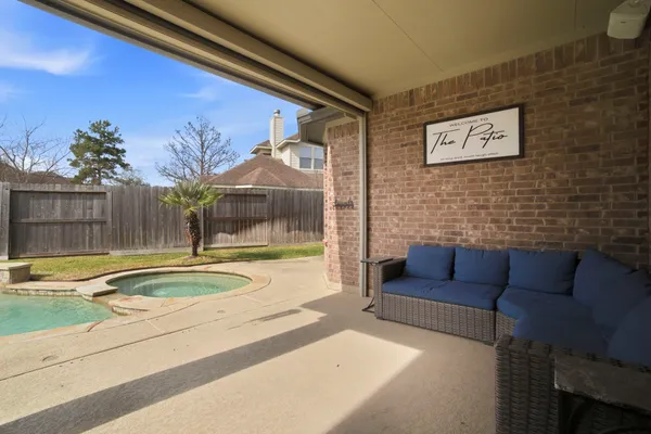 a view of a white house with a swimming pool and a yard