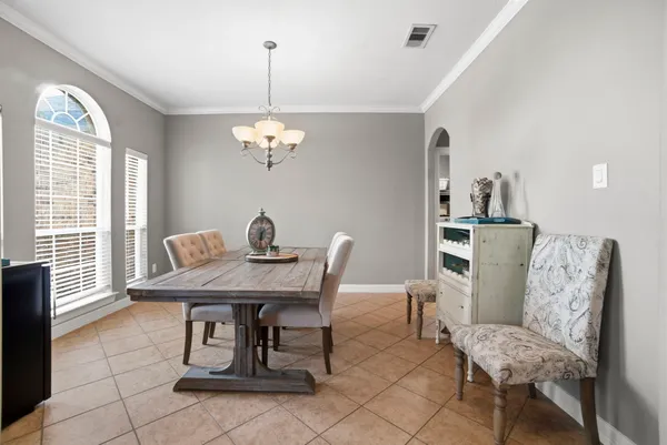 a view of a dining room with furniture and a chandelier fan
