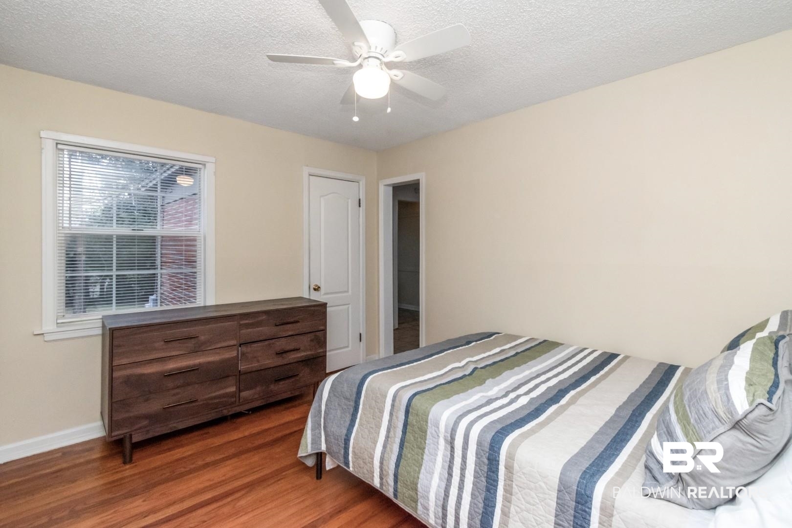 61 Nack Lane Mobile, AL 36608 - Photo 12 of 25 Bedroom featuring ceiling fan, dark hardwood / wood-style floors, and a textured ceiling