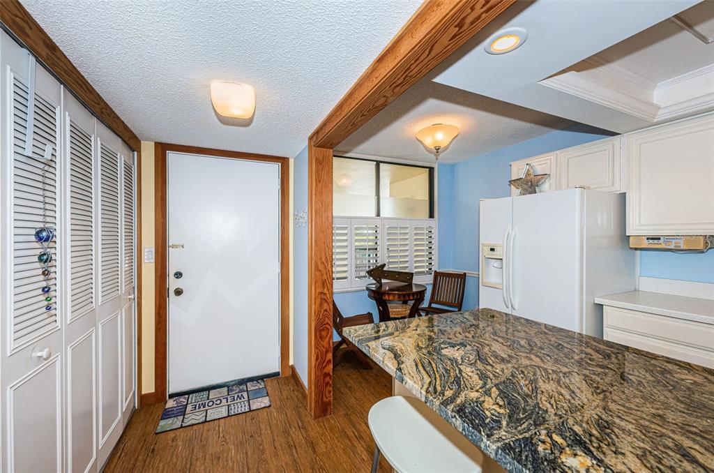 9495 Blind Pass Road, Unit 205 St. Pete Beach, FL 33706 - Photo 16 of 71 a bedroom with furniture and a window