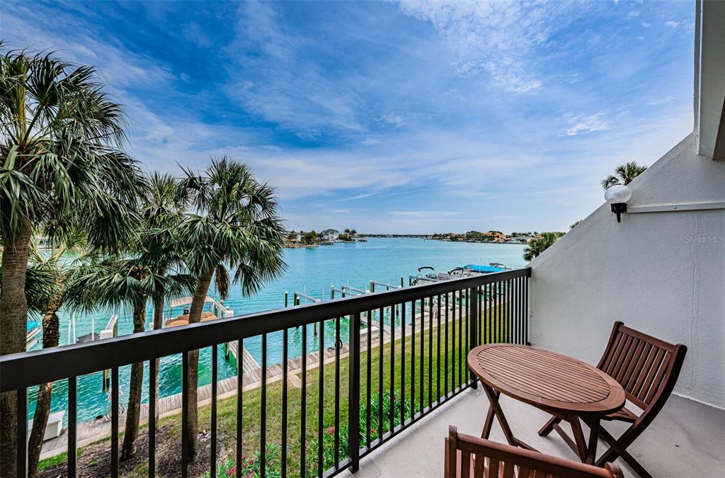 9495 Blind Pass Road, Unit 205 St. Pete Beach, FL 33706 - Photo 32 of 71 a view of a two chairs in the balcony