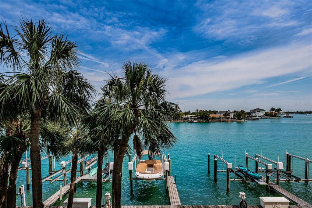 9495 Blind Pass Road, Unit 205 St. Pete Beach, FL 33706 - Photo 35 of 71 a view of a lake with a palm tree