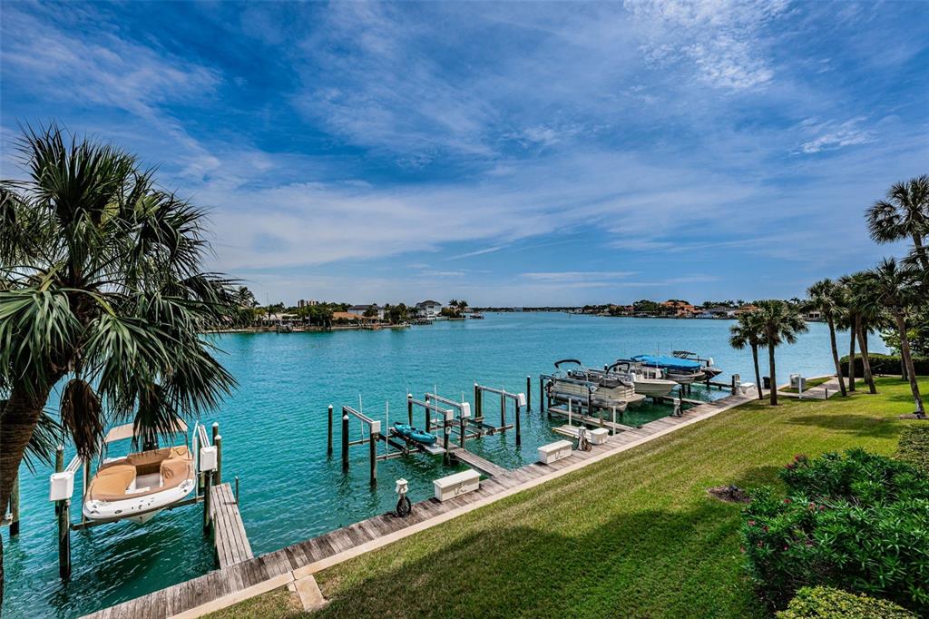 9495 Blind Pass Road, Unit 205 St. Pete Beach, FL 33706 - Photo 36 of 71 a view of a lake with a yard