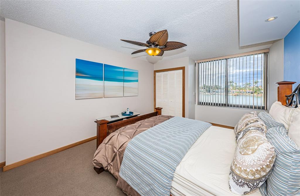 9495 Blind Pass Road, Unit 205 St. Pete Beach, FL 33706 - Photo 38 of 71 a bedroom with a bed and a window