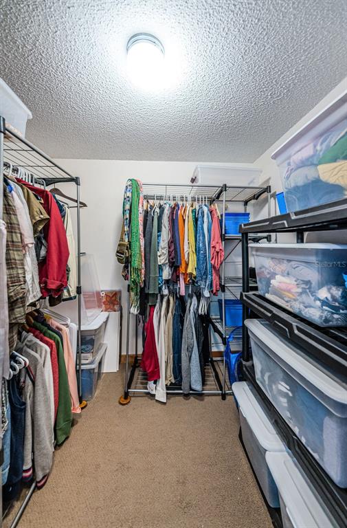 9495 Blind Pass Road, Unit 205 St. Pete Beach, FL 33706 - Photo 42 of 71 a view of walk in closet with clothes