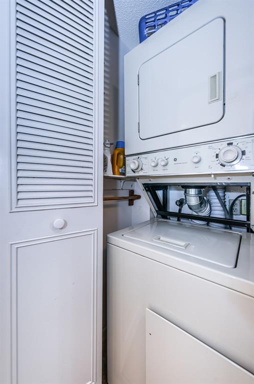 9495 Blind Pass Road, Unit 205 St. Pete Beach, FL 33706 - Photo 46 of 71 a utility room with dryer and washer