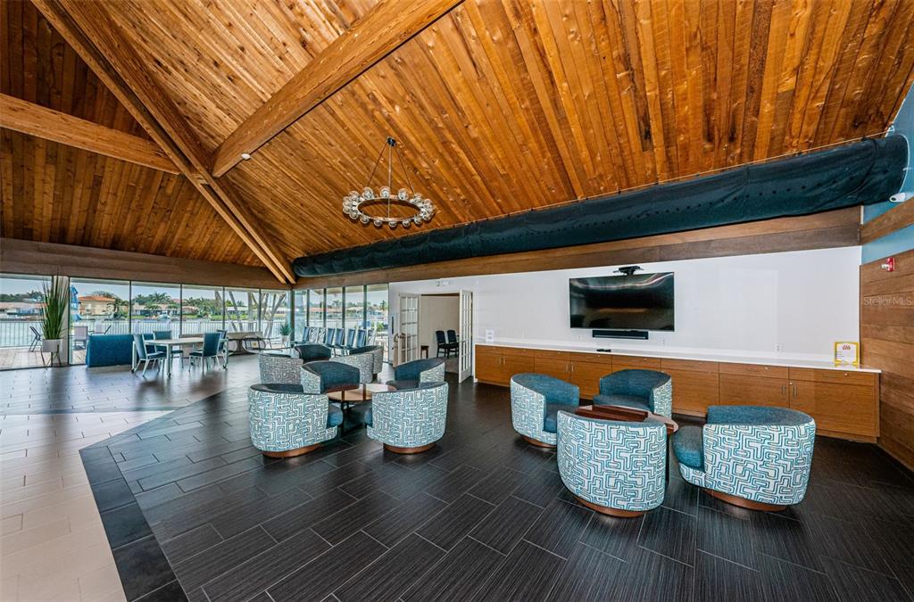 9495 Blind Pass Road, Unit 205 St. Pete Beach, FL 33706 - Photo 51 of 71 a living room with furniture and wooden floor