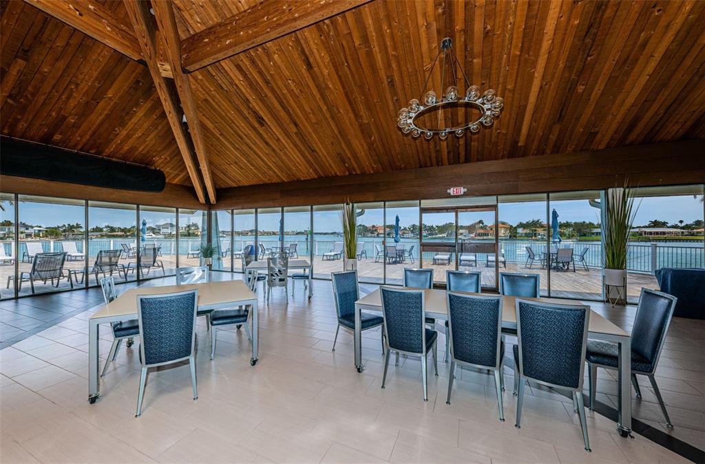 9495 Blind Pass Road, Unit 205 St. Pete Beach, FL 33706 - Photo 53 of 71 a view of a dining room with furniture window and outside view
