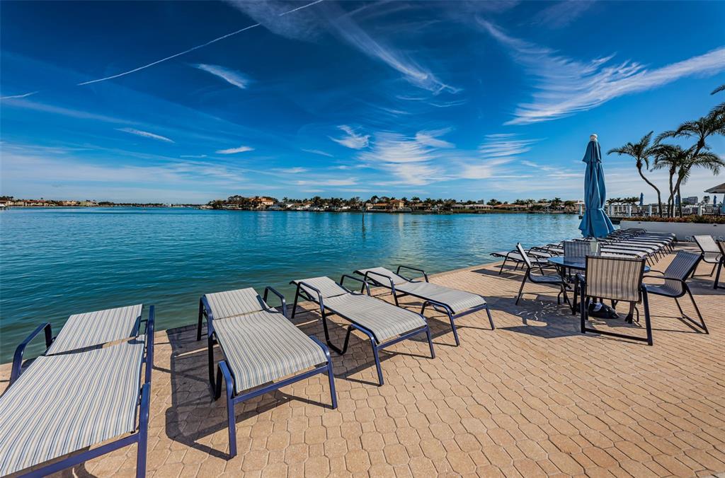 9495 Blind Pass Road, Unit 205 St. Pete Beach, FL 33706 - Photo 56 of 71 a view of a terrace with seating area and lake view