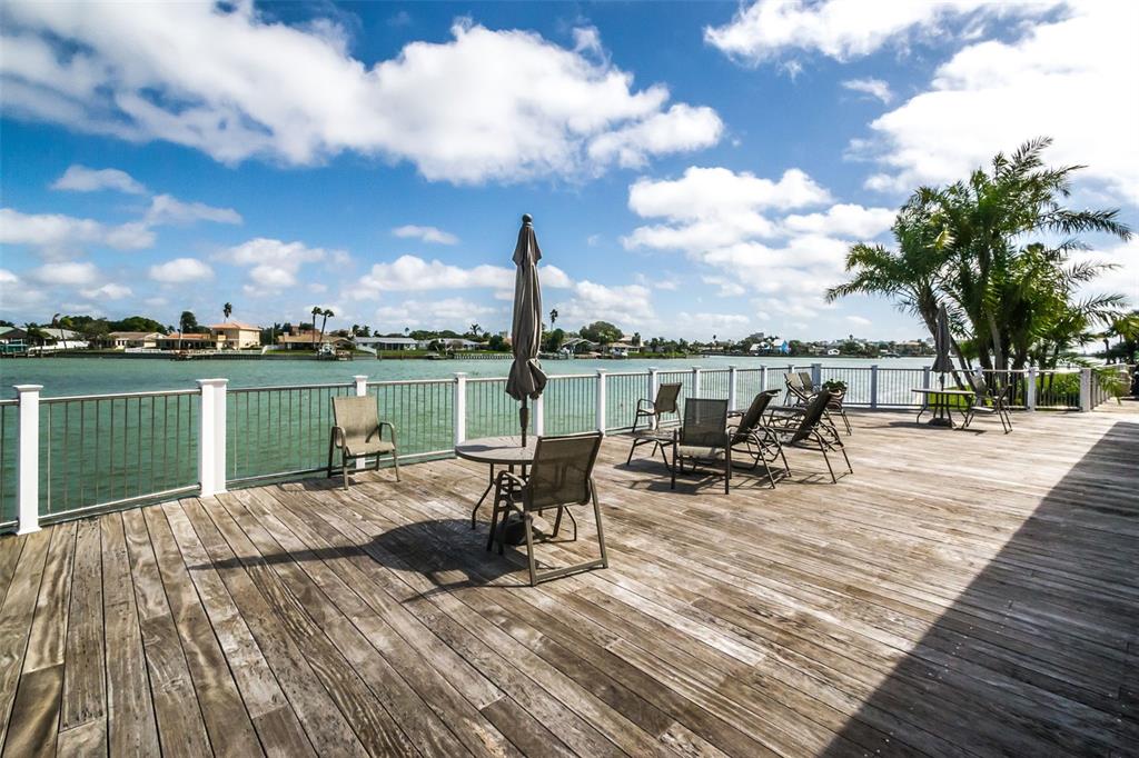 9495 Blind Pass Road, Unit 205 St. Pete Beach, FL 33706 - Photo 58 of 71 a view of a lake with tables and chairs