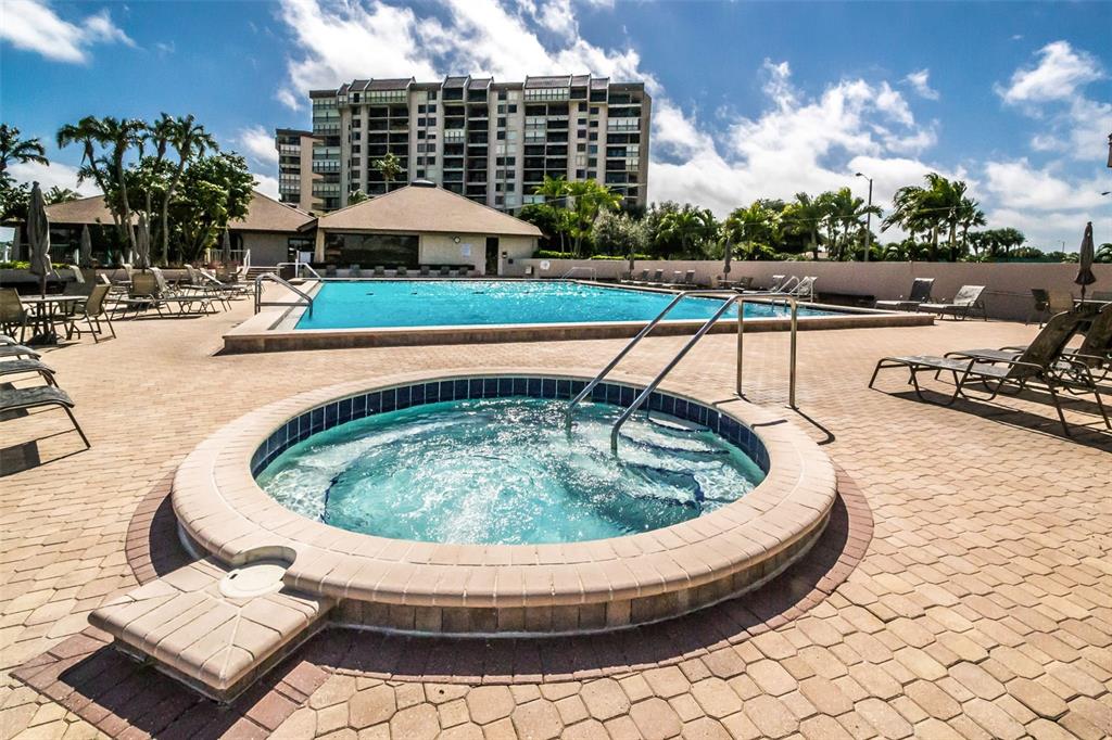 9495 Blind Pass Road, Unit 205 St. Pete Beach, FL 33706 - Photo 60 of 71 a view of a swimming pool with a patio