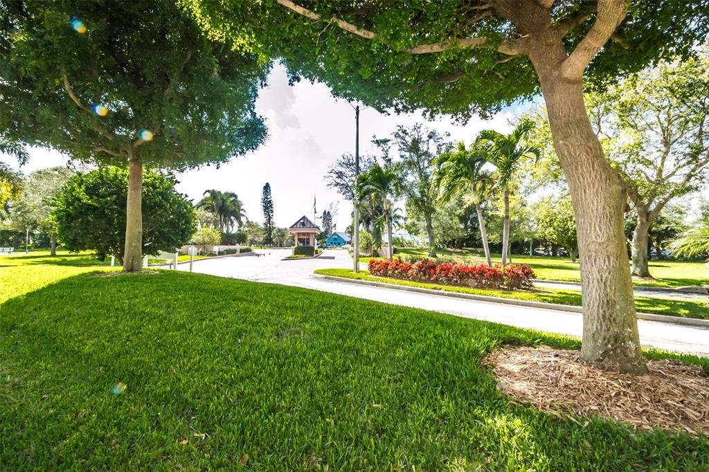 9495 Blind Pass Road, Unit 205 St. Pete Beach, FL 33706 - Photo 66 of 71 a view of yard with swimming pool and green space