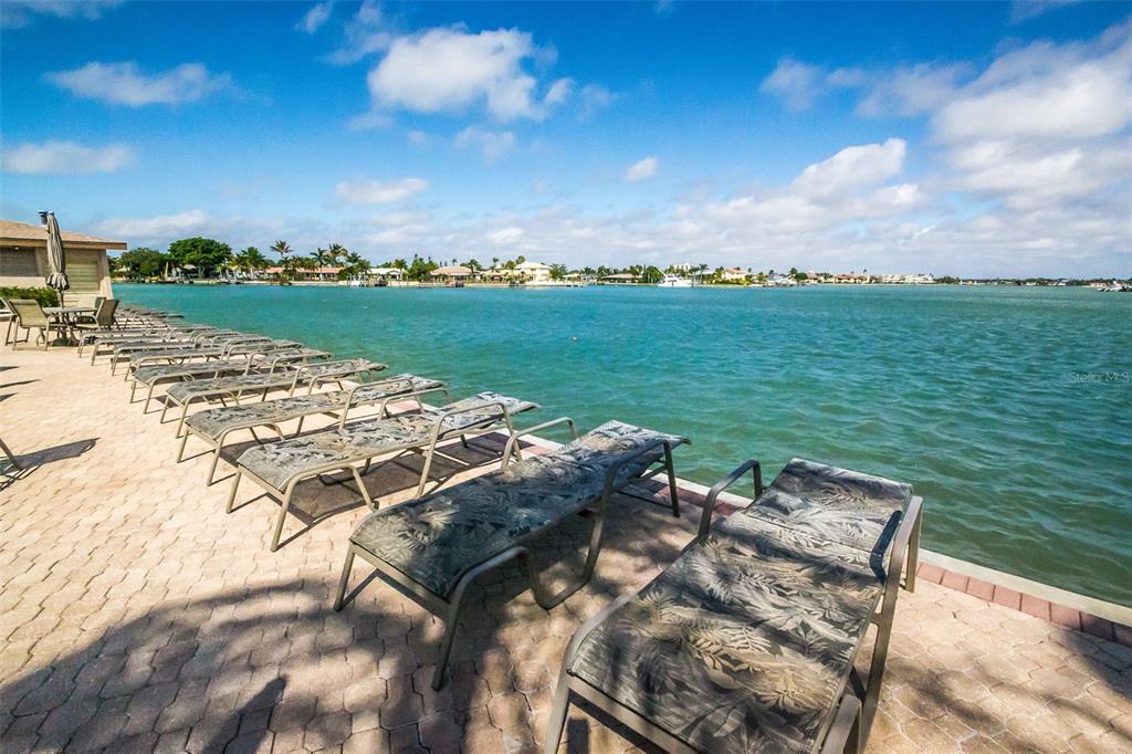 9495 Blind Pass Road, Unit 205 St. Pete Beach, FL 33706 - Photo 9 of 71 a view of a lake from a yard