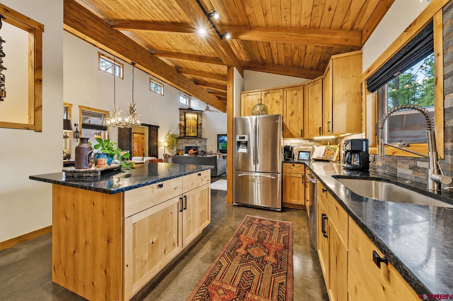 24 Monarch Crest Trail Durango, CO 81301 - Photo 13 of 45 a kitchen with stainless steel appliances granite countertop a stove a refrigerator a sink and dishwasher with wooden floor