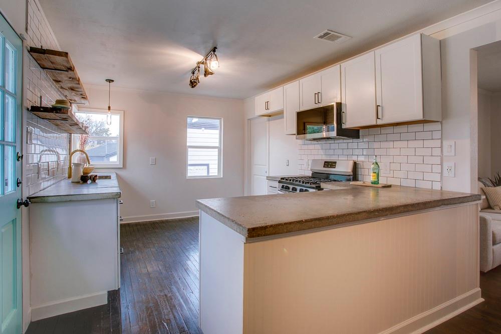 1331 Michigan Avenue Dallas, TX 75216 - Photo 11 of 40 a kitchen with stainless steel appliances granite countertop a sink stove and microwave