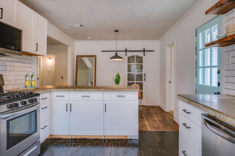1331 Michigan Avenue Dallas, TX 75216 - Photo 13 of 40 a kitchen with a sink stove and cabinets