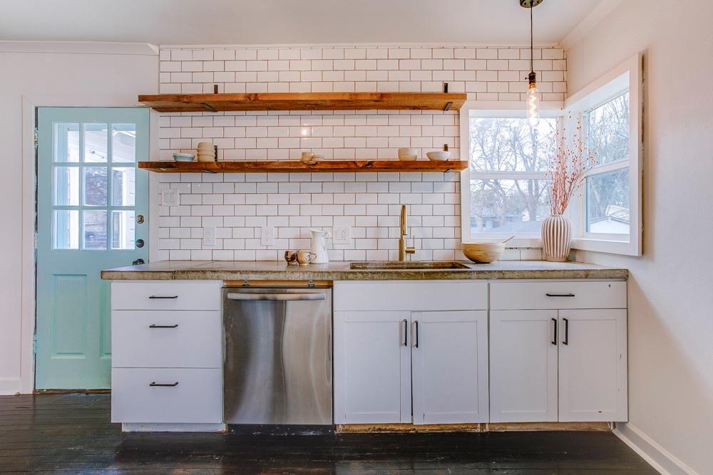 1331 Michigan Avenue Dallas, TX 75216 - Photo 16 of 40 a kitchen with stainless steel appliances granite countertop a sink dishwasher a stove and white cabinets