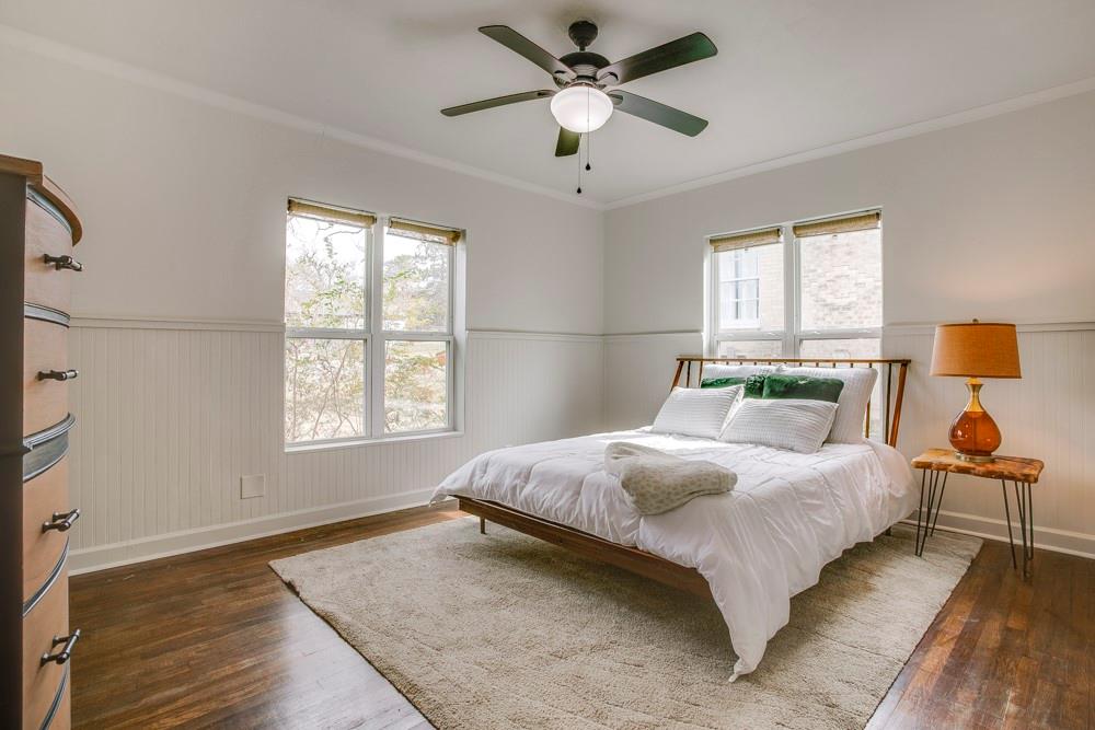 1331 Michigan Avenue Dallas, TX 75216 - Photo 20 of 40 a bedroom with a bed and dresser with wooden floor