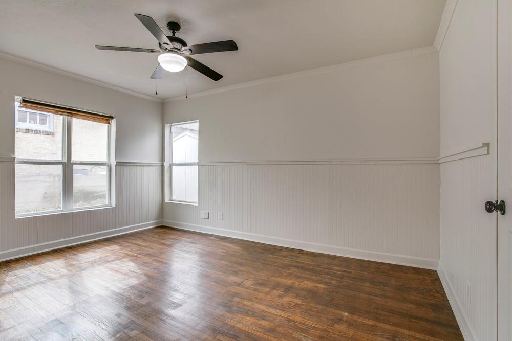 1331 Michigan Avenue Dallas, TX 75216 - Photo 23 of 40 an empty room with wooden floor fan and windows