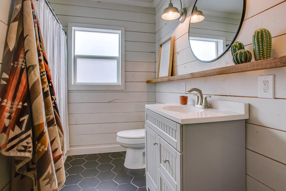 1331 Michigan Avenue Dallas, TX 75216 - Photo 26 of 40 a bathroom with a sink a toilet and a mirror