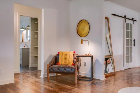 a living room with furniture and a mirror