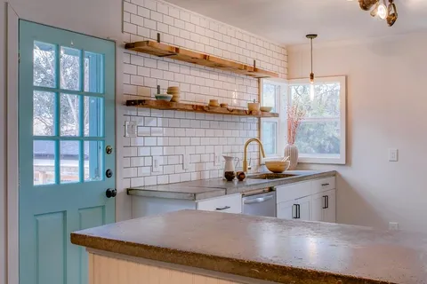 a kitchen with stainless steel appliances a sink stove and window