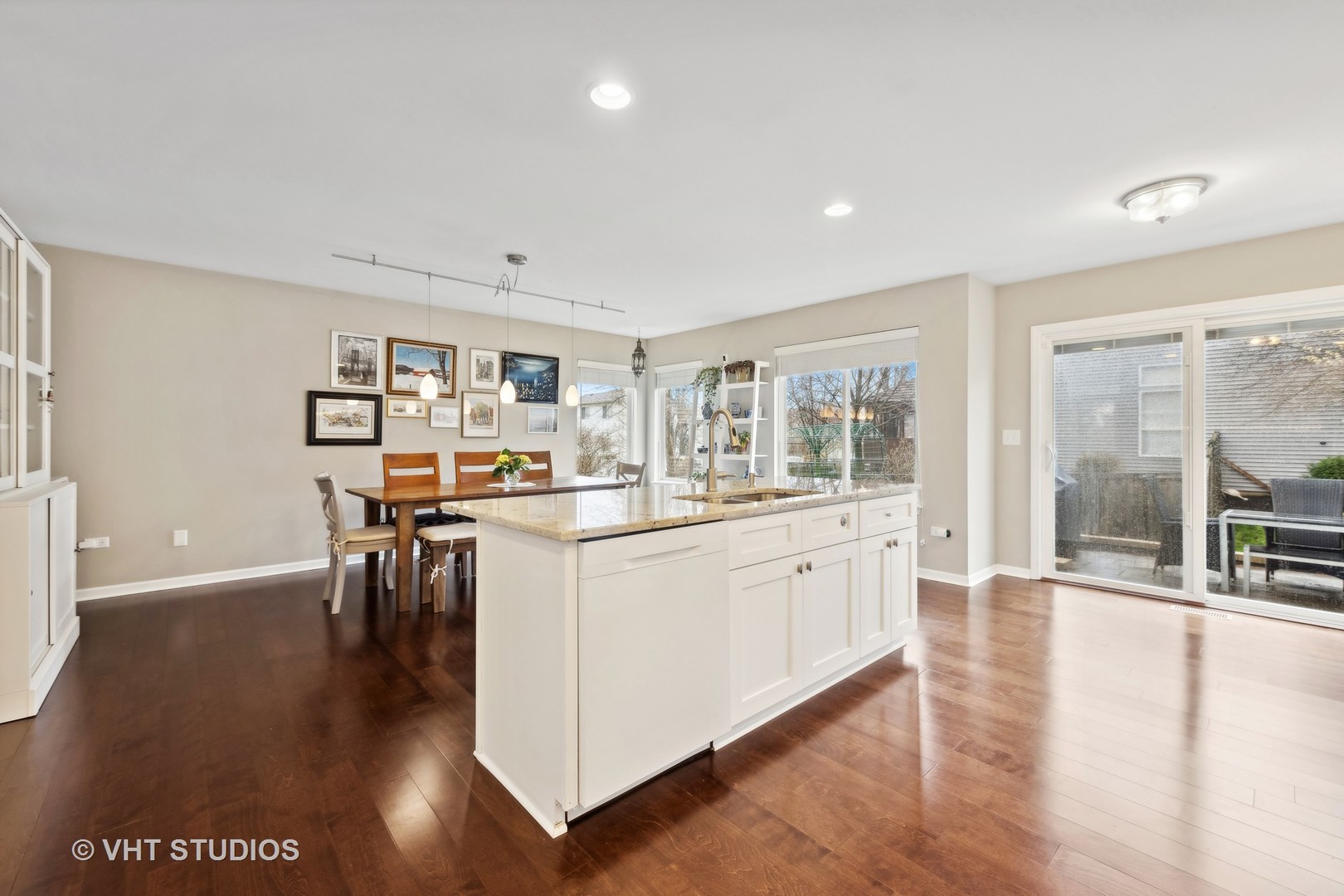 230 Willow Bend Bolingbrook, IL 60490 - Photo 12 of 29 a kitchen with stainless steel appliances granite countertop a stove top oven a sink a dining table and chairs
