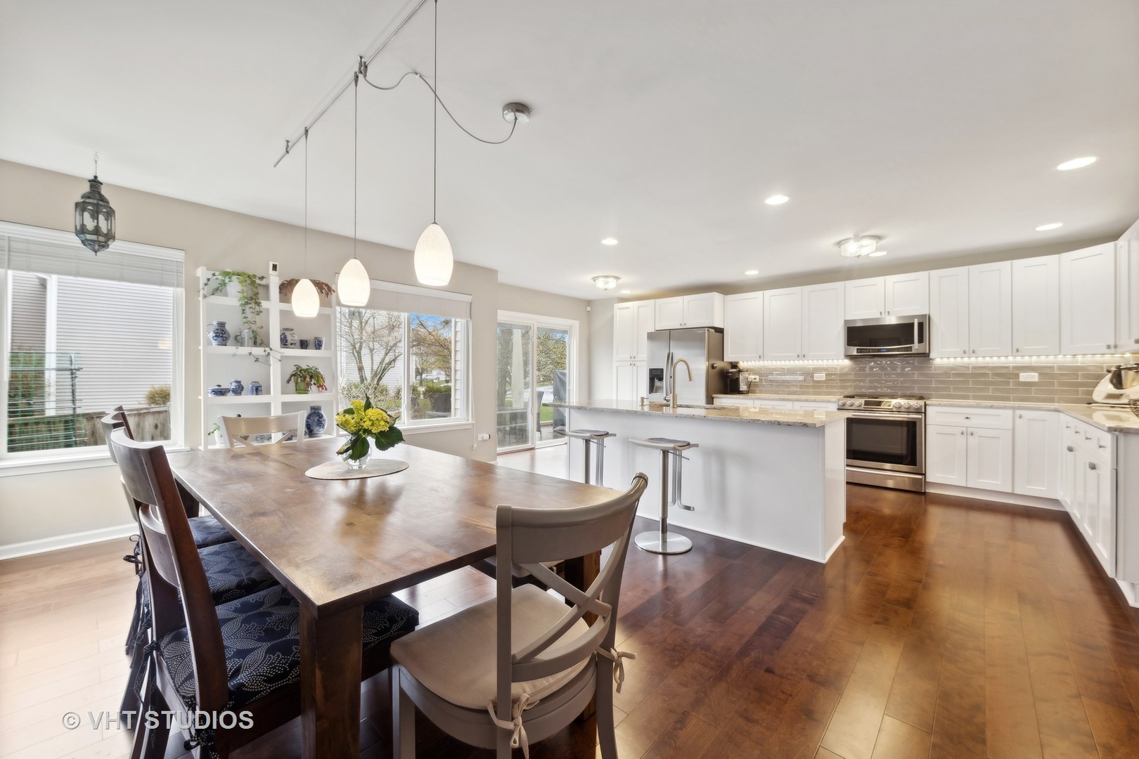 230 Willow Bend Bolingbrook, IL 60490 - Photo 10 of 29 a view of a dining room and livingroom with furniture wooden floor a chandelier