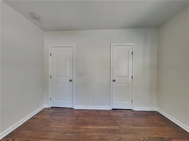 a view of an empty room and wooden floor