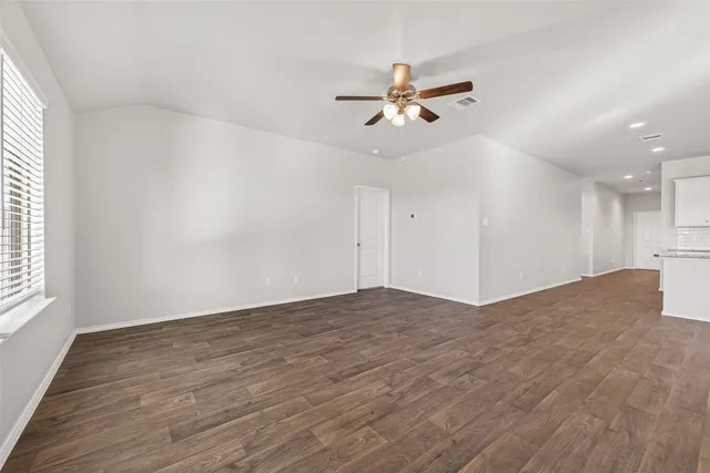 a view of a livingroom with a ceiling fan and window