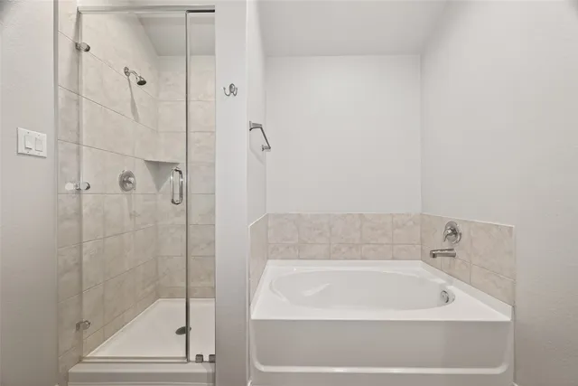 a bathroom with a bathtub and a shower