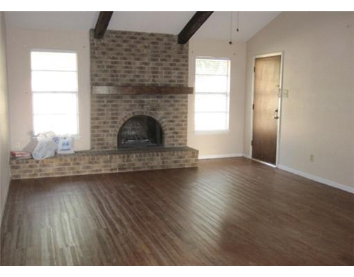 1618 Cheyenne Street Portland, TX 78374 - Photo 3 of 7 a living room with a fireplace wooden floor and a window