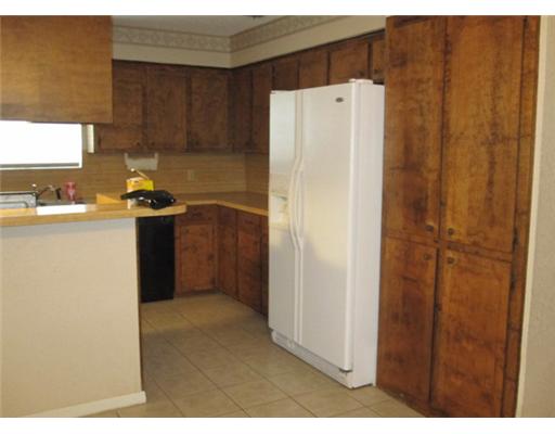 1618 Cheyenne Street Portland, TX 78374 - Photo 4 of 7 a kitchen with a refrigerator and a sink