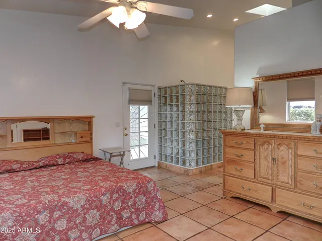 a bathroom with a granite countertop sink and a bathtub