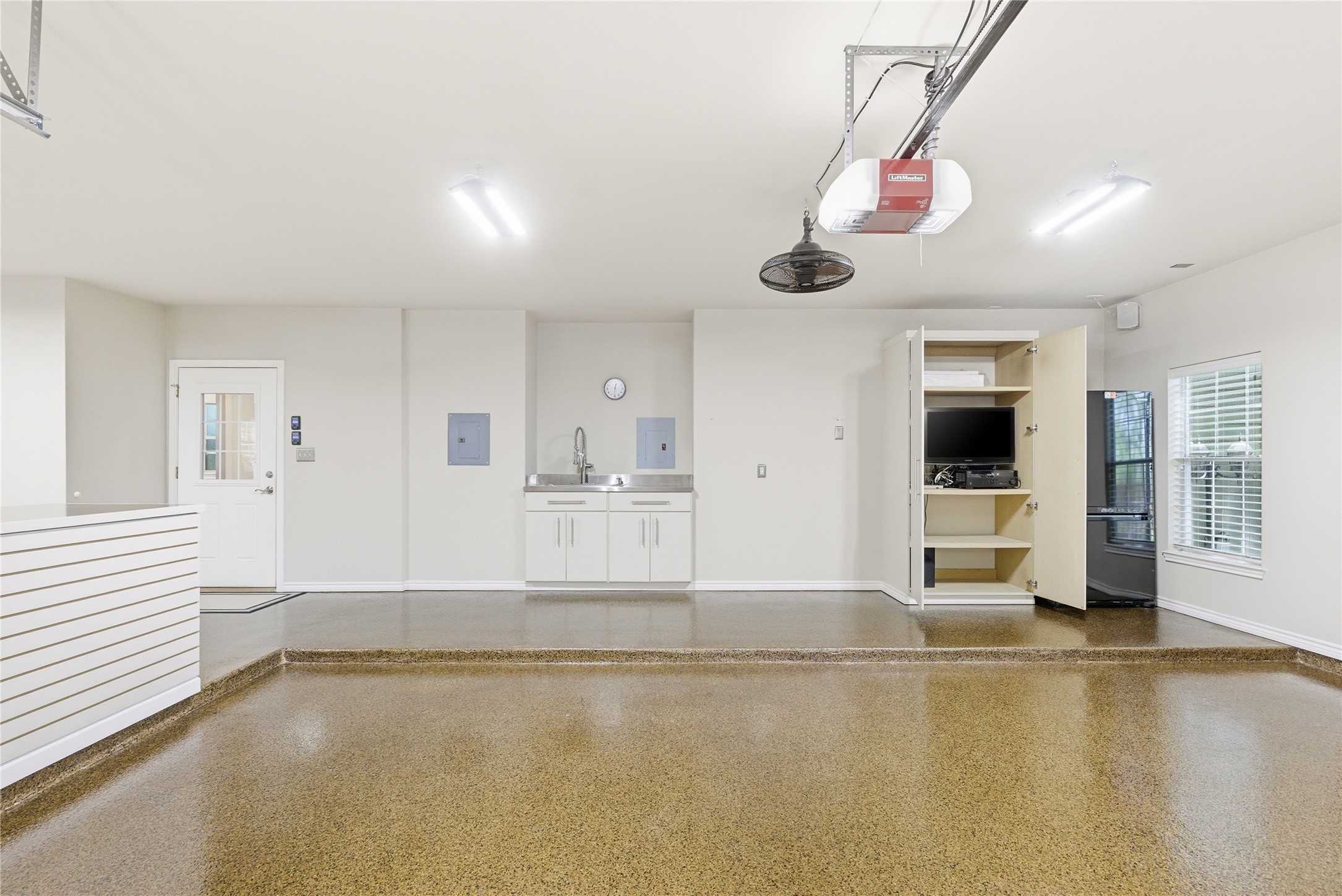 1204 Orlando Road Austin, TX 78733 - Photo 13 of 40 A well-organized garage with gleaming epoxy flooring and practical utility features.