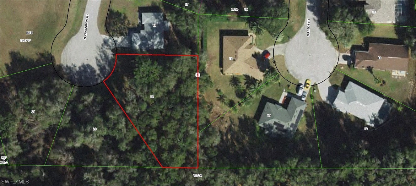 an aerial view of a house with garden space and sitting area