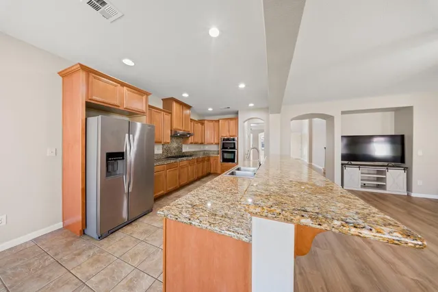 a view of kitchen with refrigerator microwave and oven