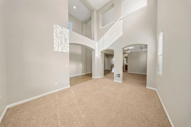 a view of a big room with closet and windows