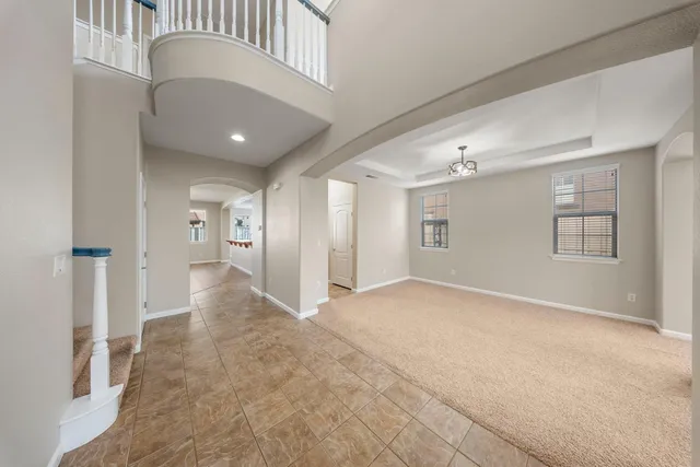 an empty room with windows and entrance