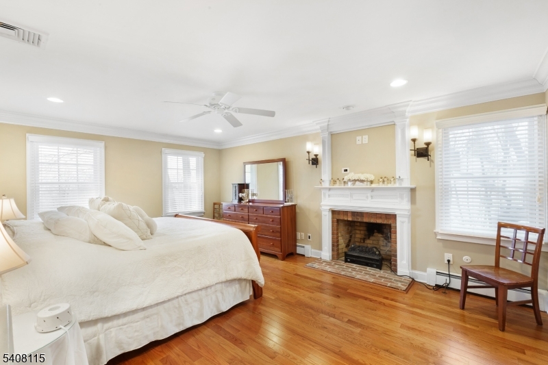 12 Waldon Road Califon, NJ 07830 - Photo 19 of 34 a bedroom with a large bed and a fireplace
