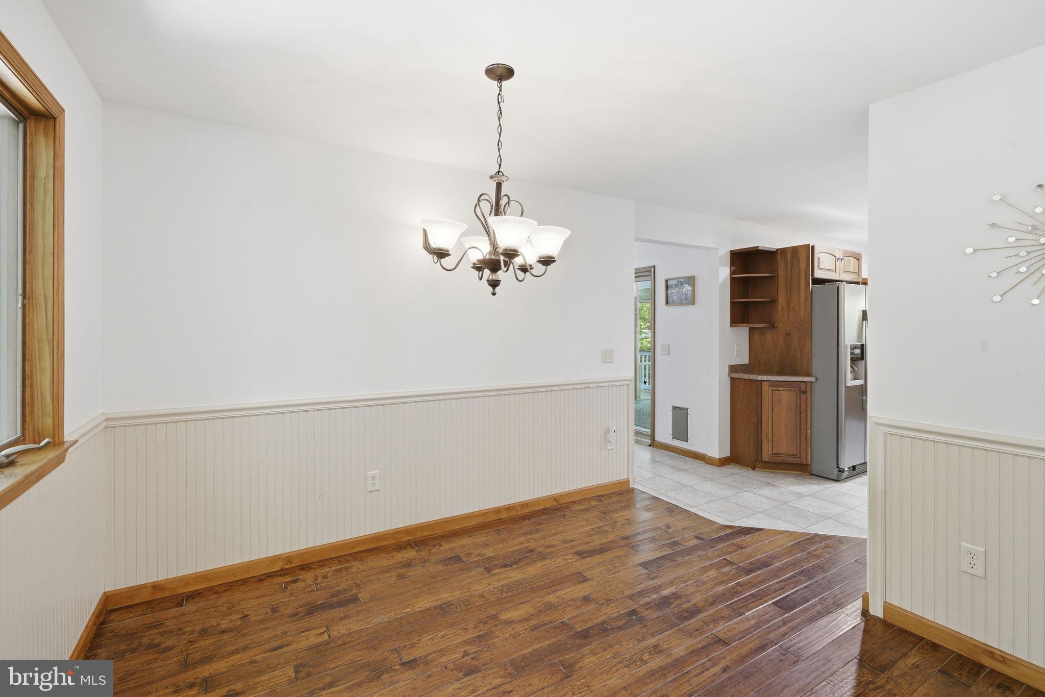 22300 Frazier Road Rock Hall, MD 21661 - Photo 9 of 38 a view of a livingroom with wooden floor and a ceiling fan