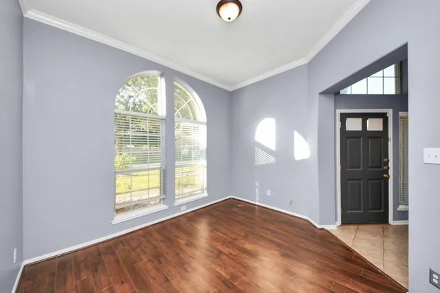 an empty room with windows and closet