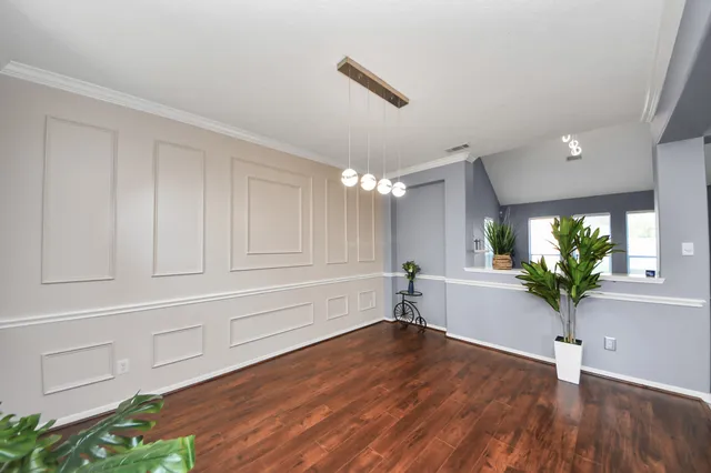 a large white kitchen with a sink and dishwasher next to a window