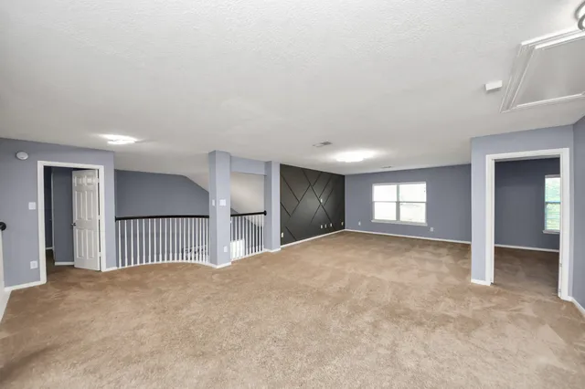 a large bathroom with a glass shower door and a mirror