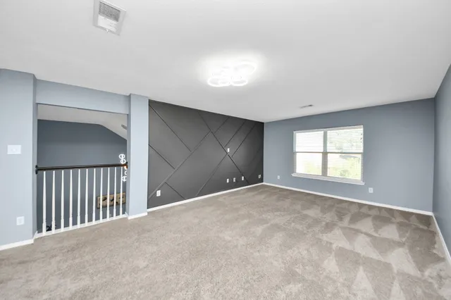 a en suite bathroom with a granite countertop tub sink and mirror