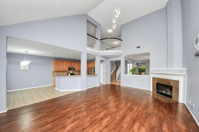 a view of an empty room with window and fire place